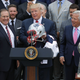 New England Patriots head coach Bill Belichick (left) and team owner Robert Kraft (right) present a football helmet to President Donald Trump during a celebration of the team’s Super Bowl victory on the South Lawn at the White House on April 19, 2017, in Washington, D.C.